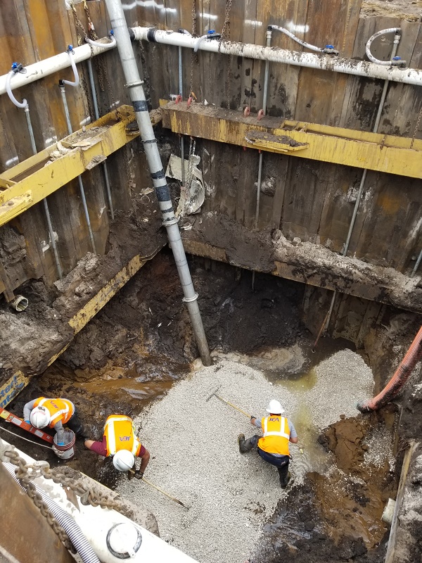 Crews Creating a Base for the Manhole Crews Creating a Base for the Manhole